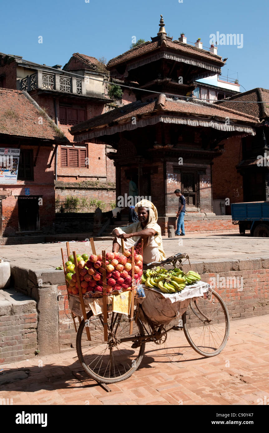 Bhaktapur is a busy city on a trading route through the mountains of Nepal. There are large holy sites and street vendors offer Stock Photo