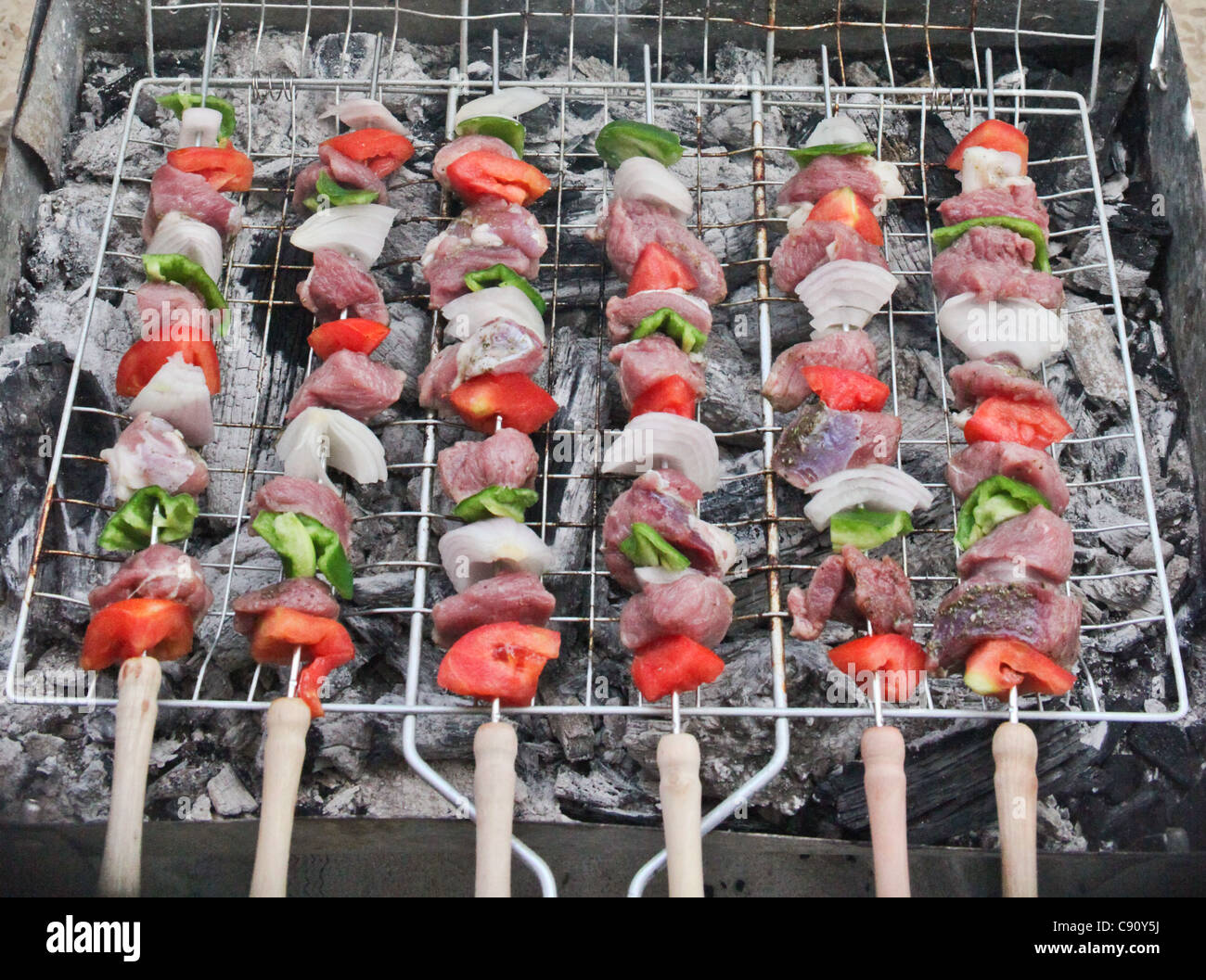 MEAT AND VEGETABLES ON A BARBECUE Stock Photo
