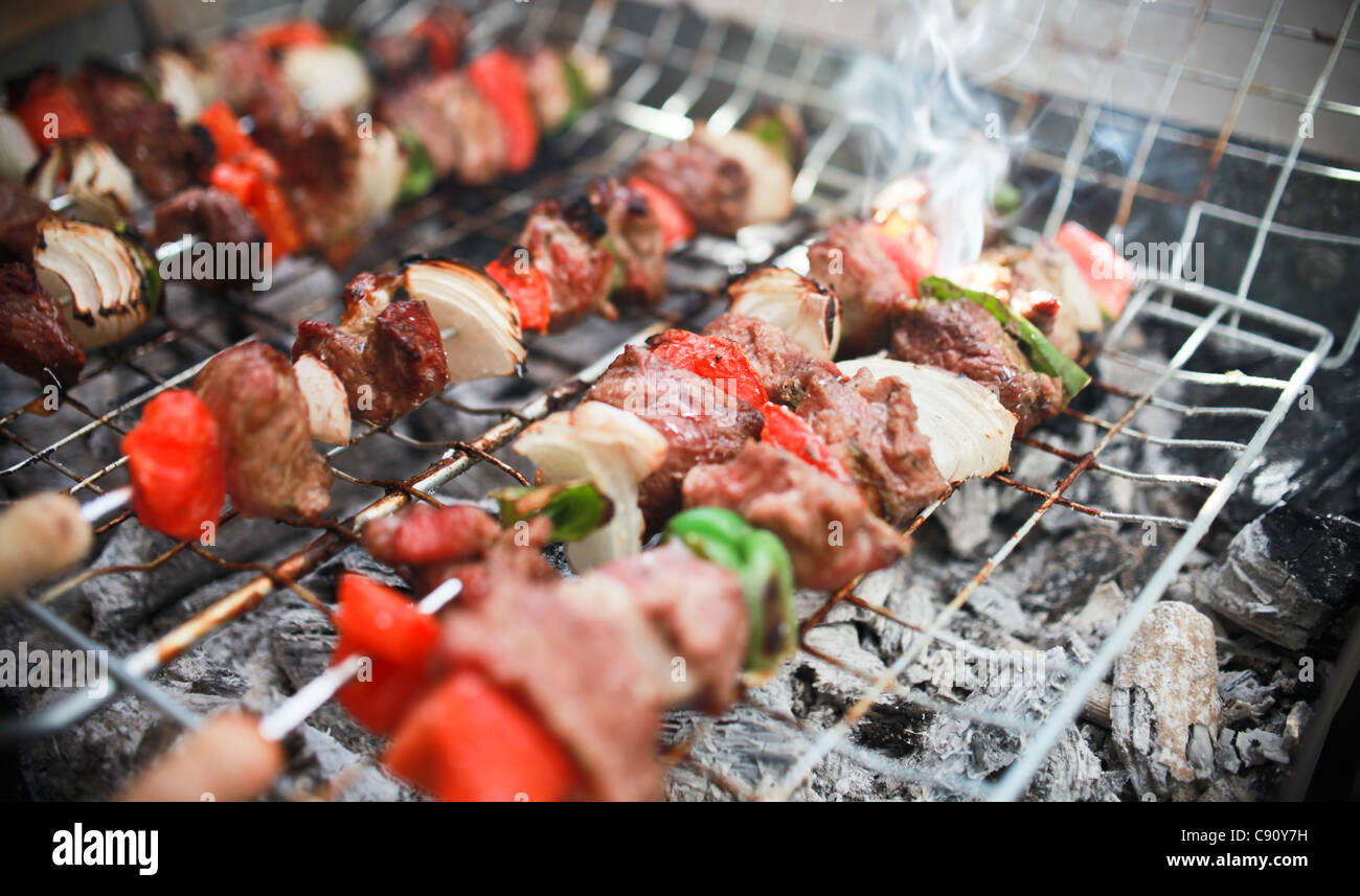 MEAT AND VEGETABLES ON A BARBECUE Stock Photo