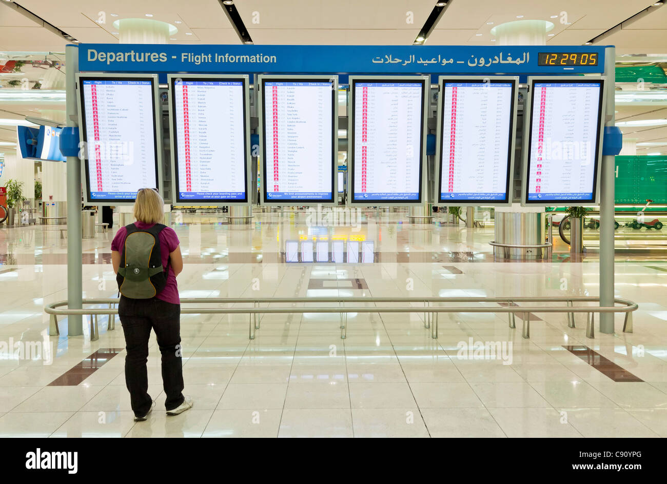 Female passenger looking at the departures board at Dubai International Airport Dubai, United Arab Emirates, UAE, Middle East Stock Photo