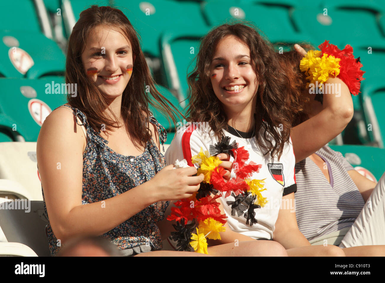Young Germany supporters in the stands smile at a 2011 FIFA Women's World Cup quarterfinal match between Germany and Japan. Stock Photo