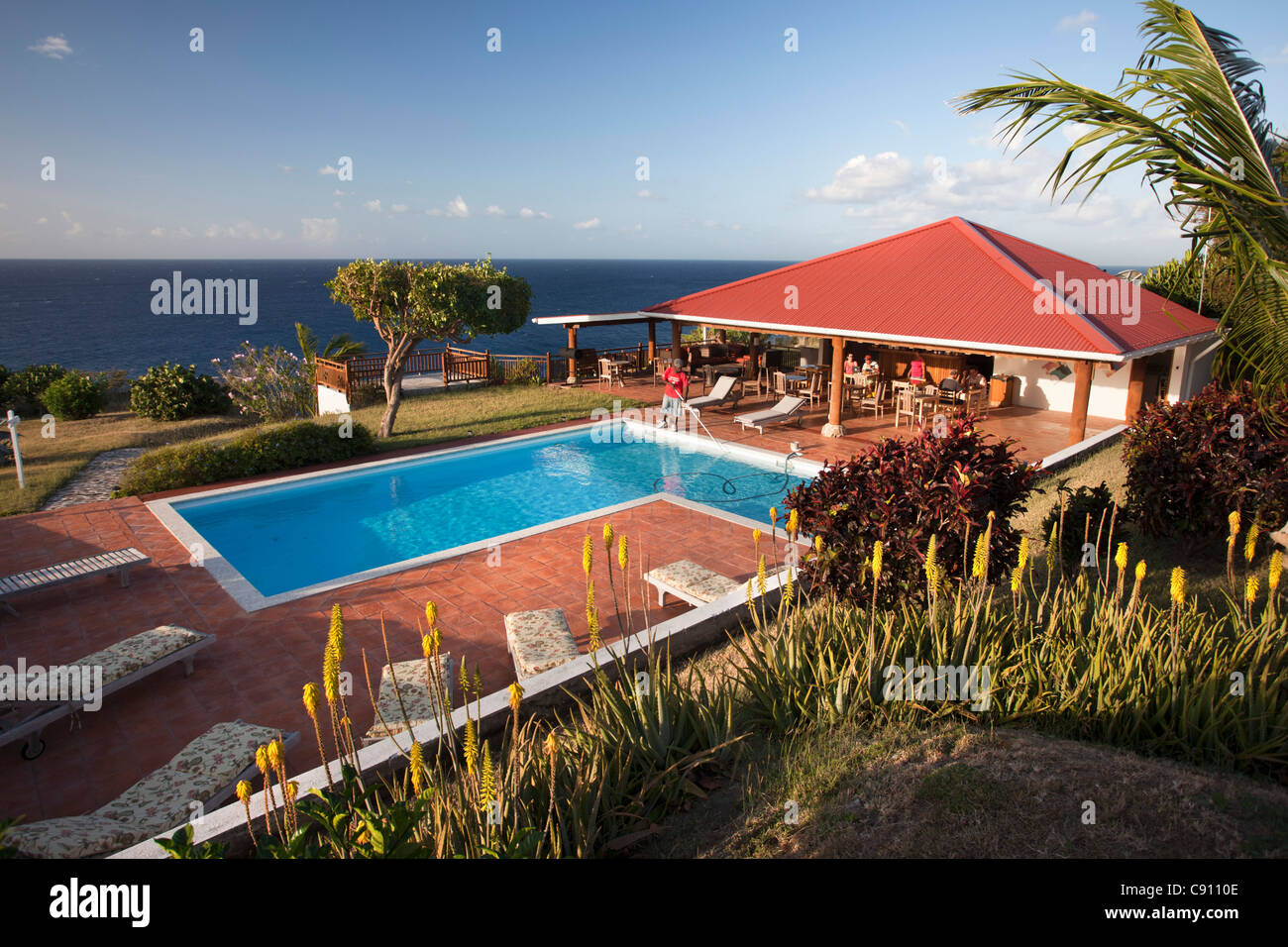 The Netherlands, Oranjestad, Sint Eustatius Island, Dutch Caribbean. Swimming pool and outdoor terrace of Statia Lodge. Stock Photo