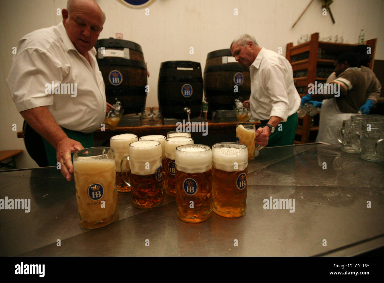 Barmen filling one litre beer masses in the Hofbrau Festzelt at the