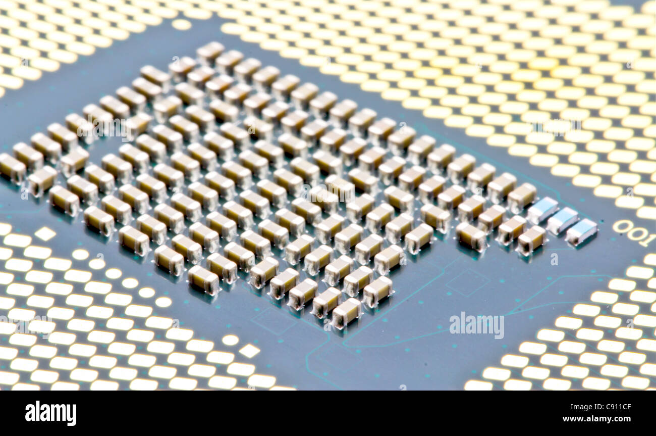 SMD components between contacts on the bottom of the PC processor Stock Photo