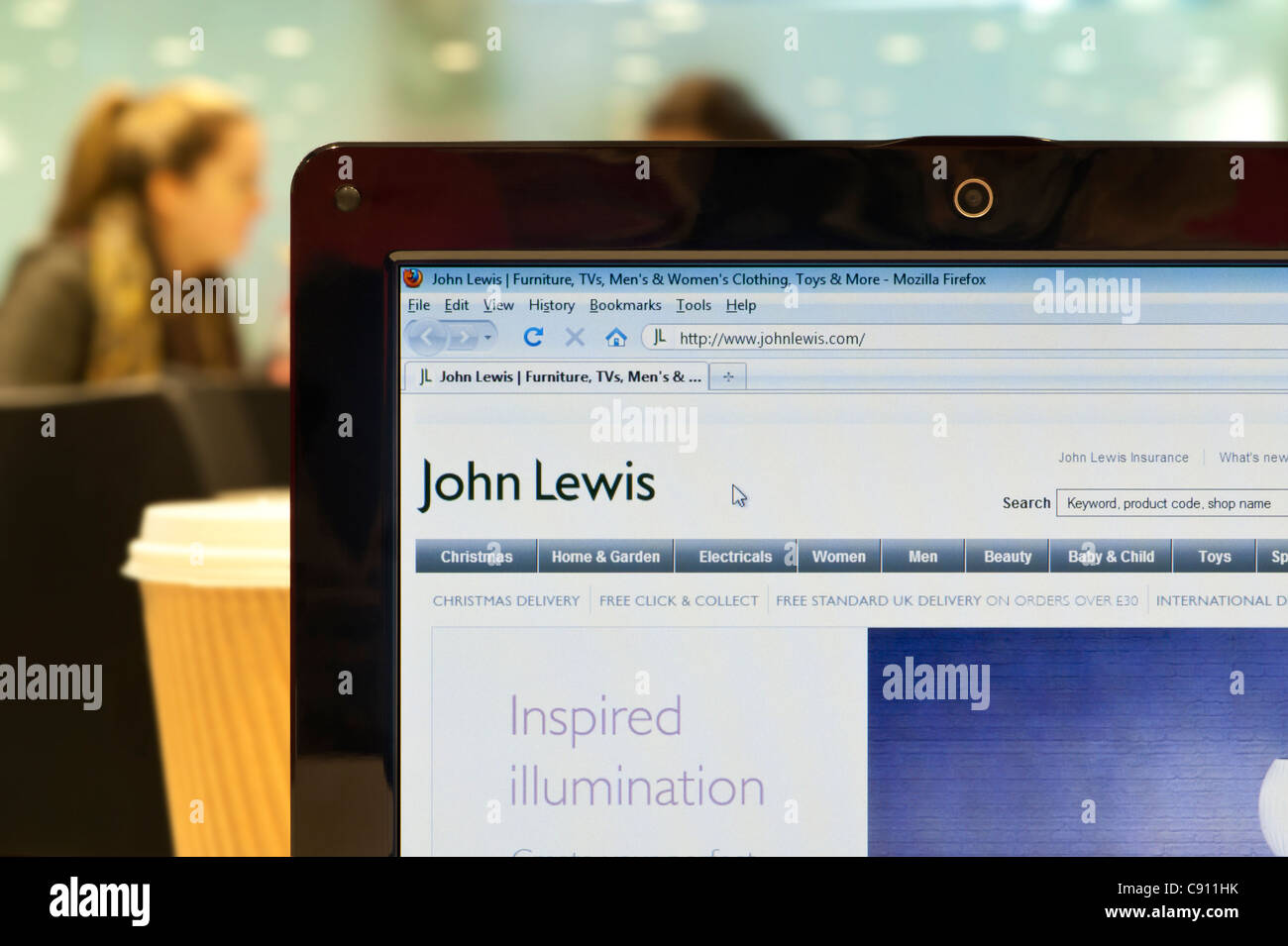 The John Lewis website shot in a coffee shop environment (Editorial use only: print, TV, e-book and editorial website). Stock Photo