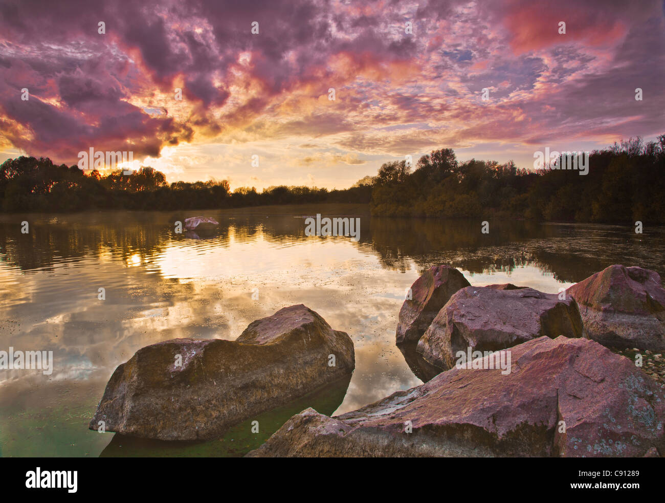 An autumn sunset over the lake at Colwick Country Park, Nottingham, Nottinghamshire, England, UK Stock Photo