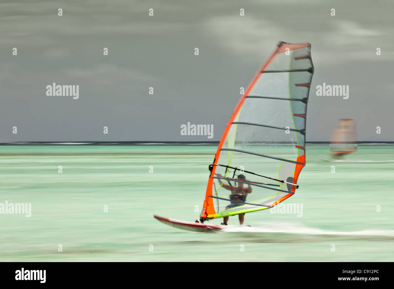 The Netherlands, Bonaire Island, Dutch Caribbean, Kralendijk, Lac Bay. Wind surfing. Blurred motion. Stock Photo