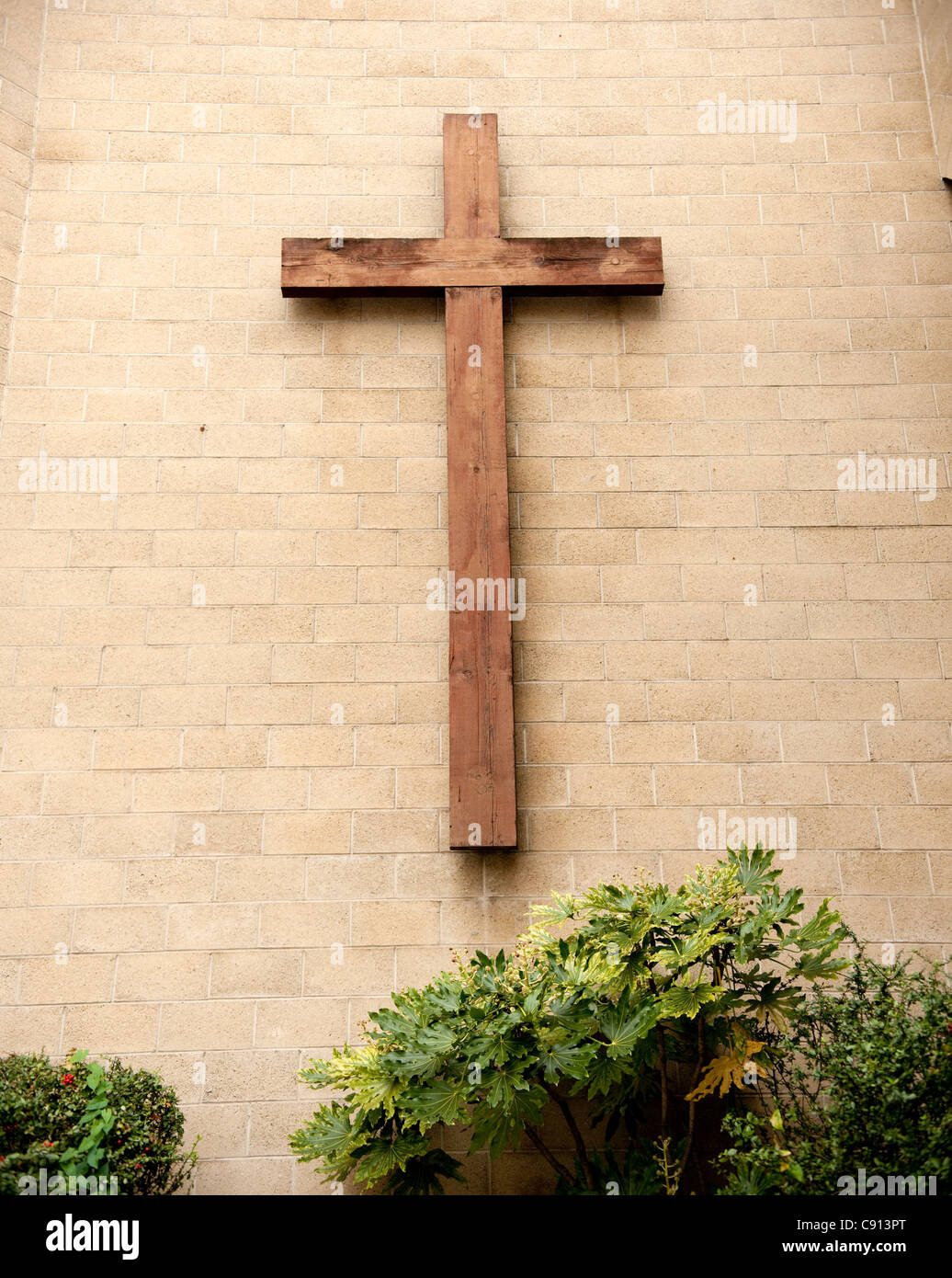 Many churches in London have large woode crosses on the building facade. Stock Photo