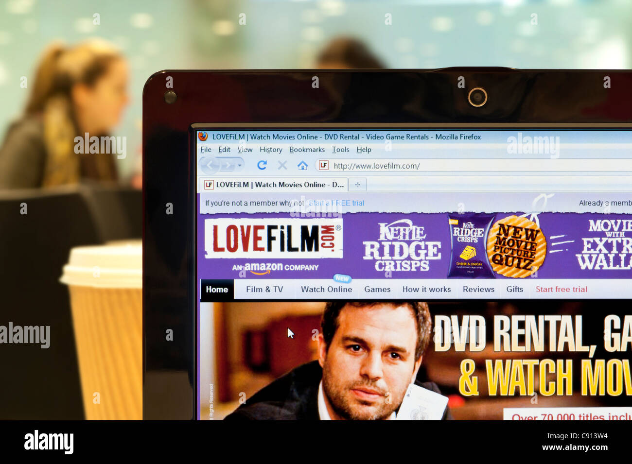 The LoveFilm website shot in a coffee shop environment (Editorial use only: print, TV, e-book and editorial website). Stock Photo