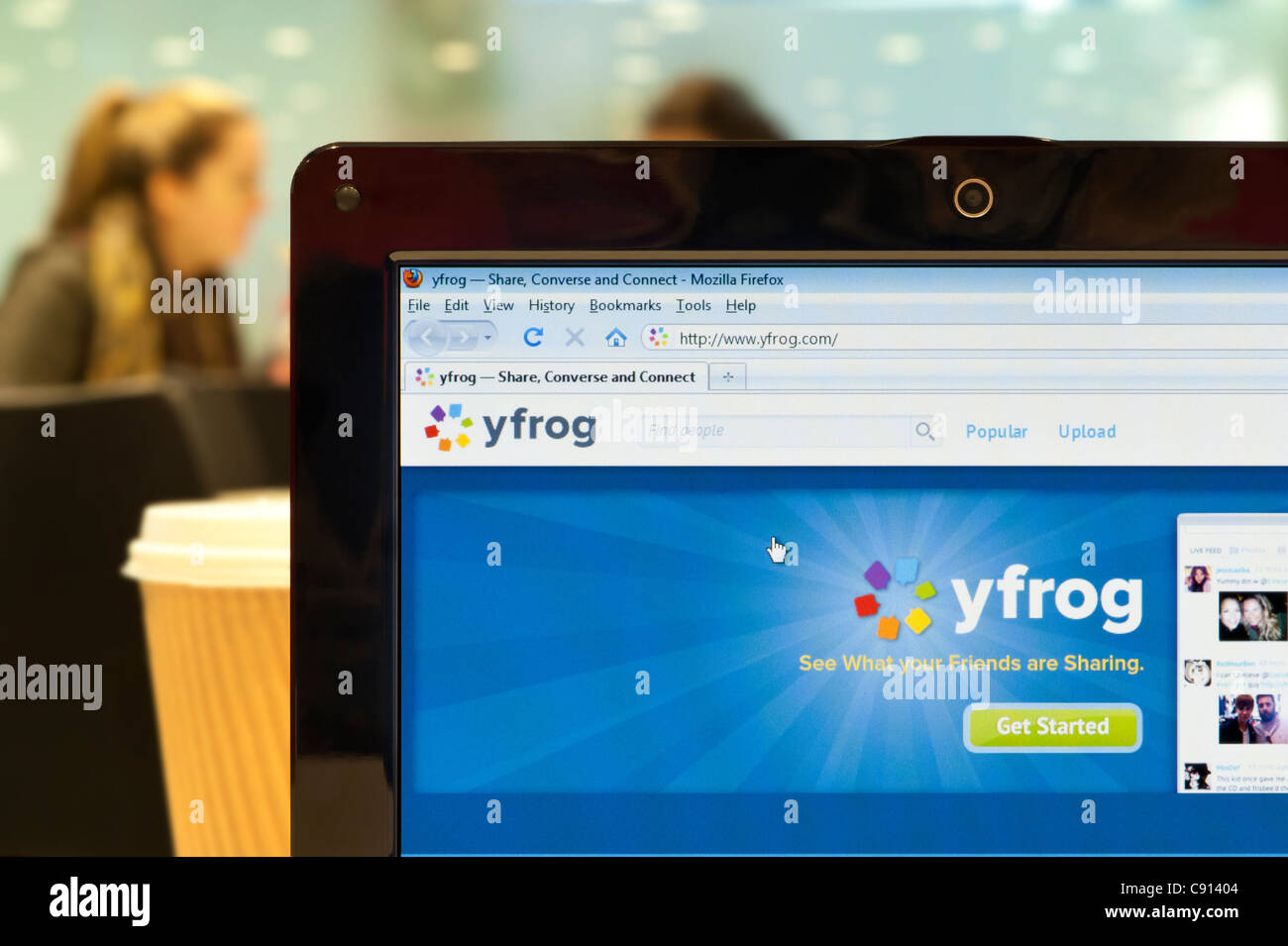 The Yfrog website shot in a coffee shop environment (Editorial use only: print, TV, e-book and editorial website). Stock Photo