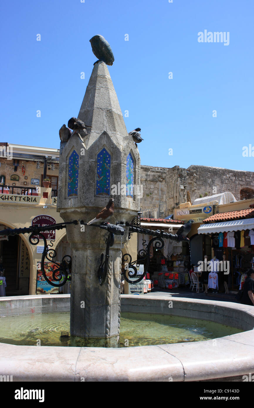 There is a fountain in Ippocrates Square in Rhodes. Rhodes historic town and fortified harbour was designated as a UNESCO World Stock Photo