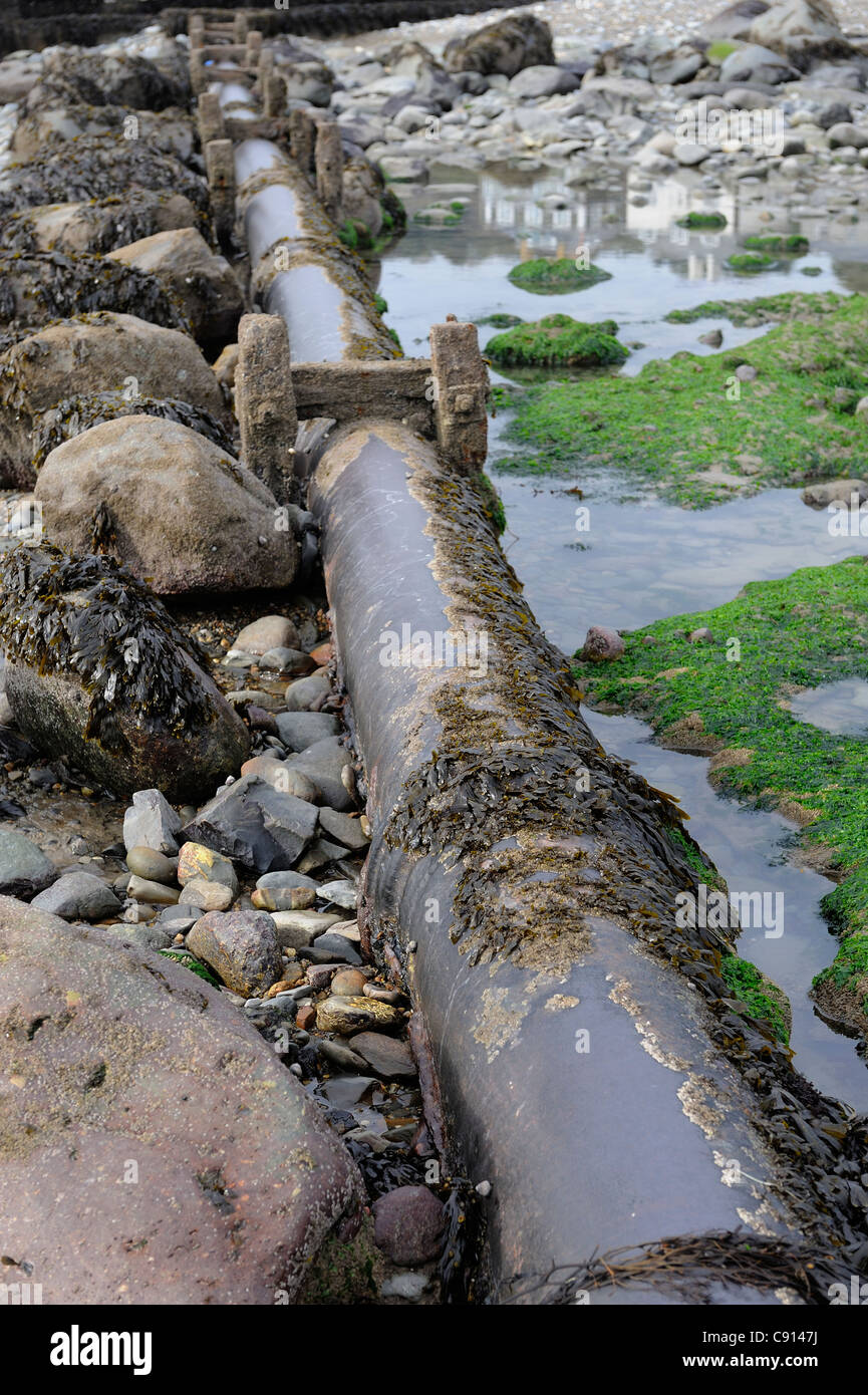 sewage water pipe traversing criccieth beach gwynedd north wales Stock Photo