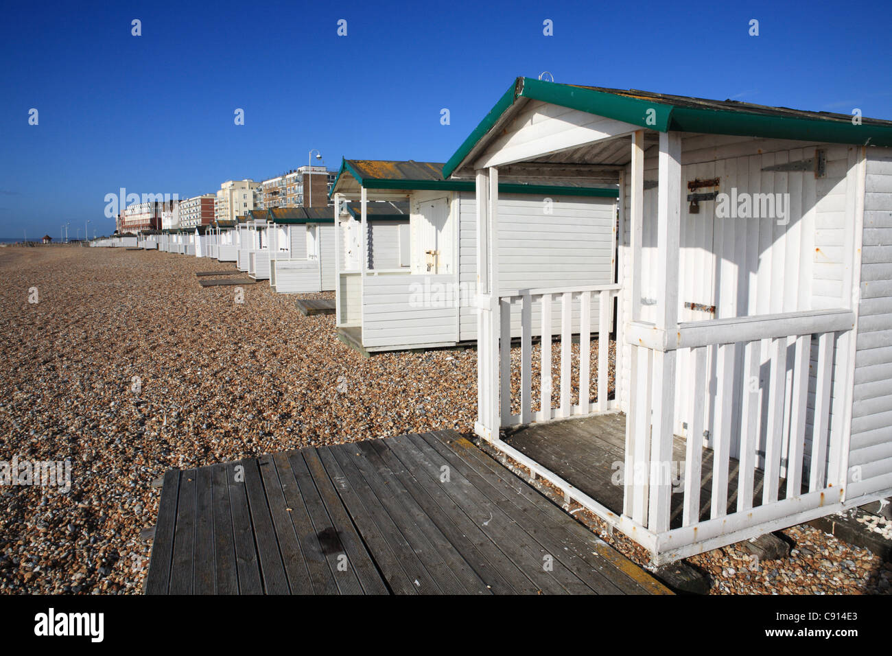 A row of white painted beach huts at Bexhill, East Sussex, South Coast