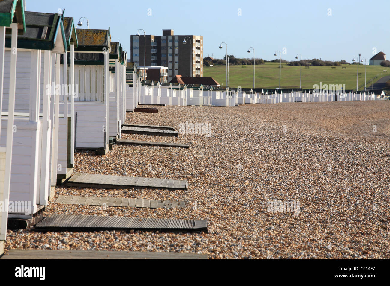 A row of white painted beach huts at Bexhill, East Sussex, South Coast