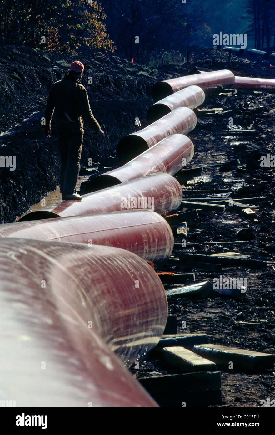 Welder walking along the construction site of a thirty inch pipeline in rural West Virginia, USA Stock Photo