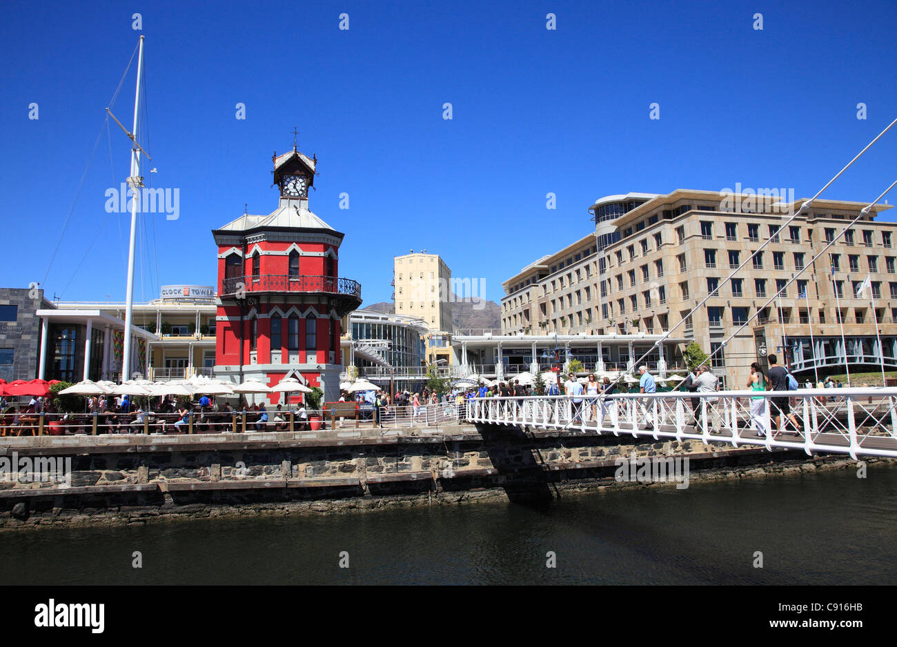 The Red Clock tower is a landmark and meeting point in Victoria and Albert Dock on the harbour quayside in Cape  Town. Stock Photo