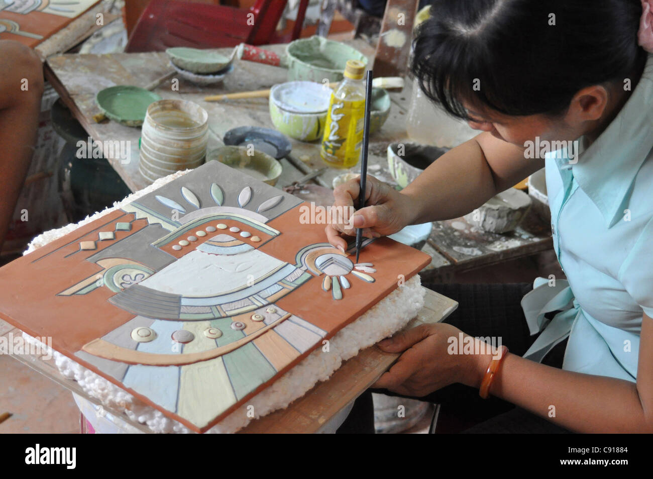 Ceramic workers make clay tiles and glazed wares ceramics in the