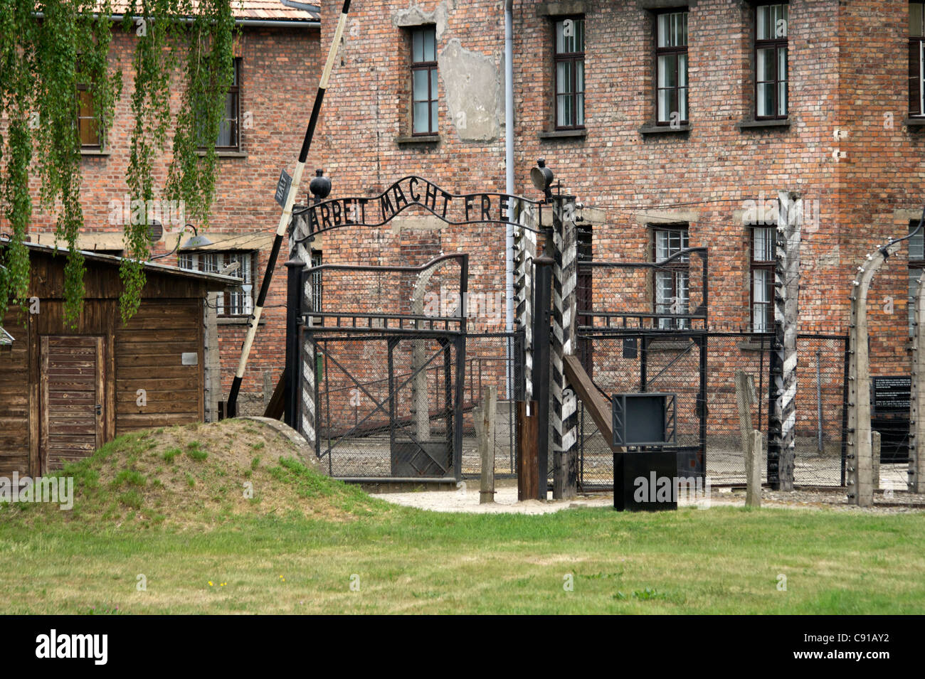 Gate to the entrance of Auschwitz 1 concentration camp with original metal signage 'Arbeit Macht Frei' Work makes you free and Stock Photo