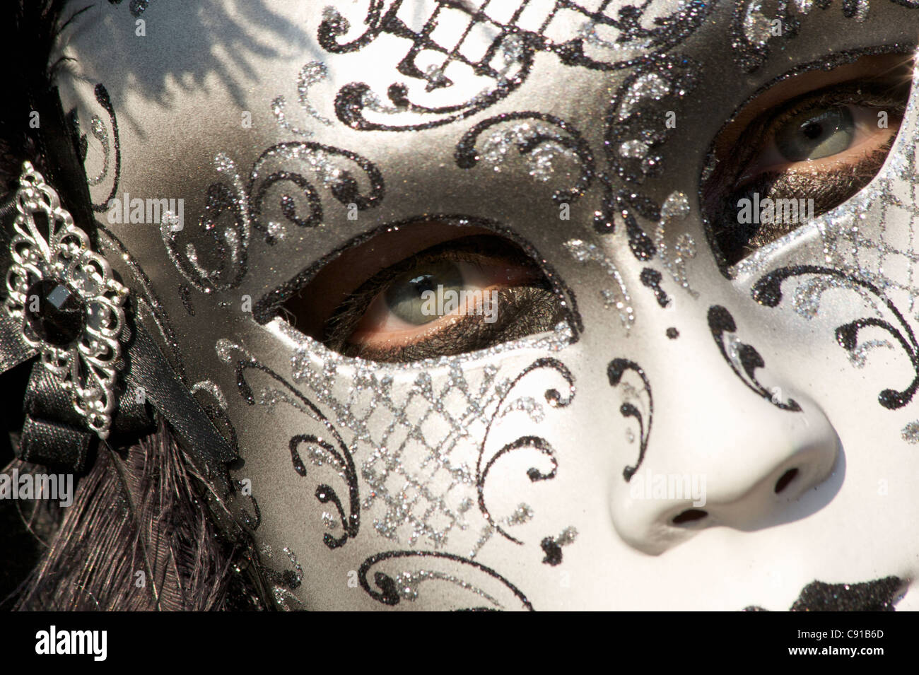 Woman wearing a mask with black eye makeup. Italy