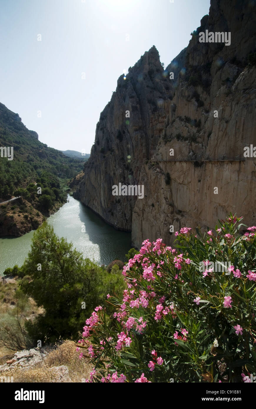Remains of the 1920s Camino del Rey concrete walkway are still standing on the cliffs of the Embalse de Guadalhorceto the other Stock Photo