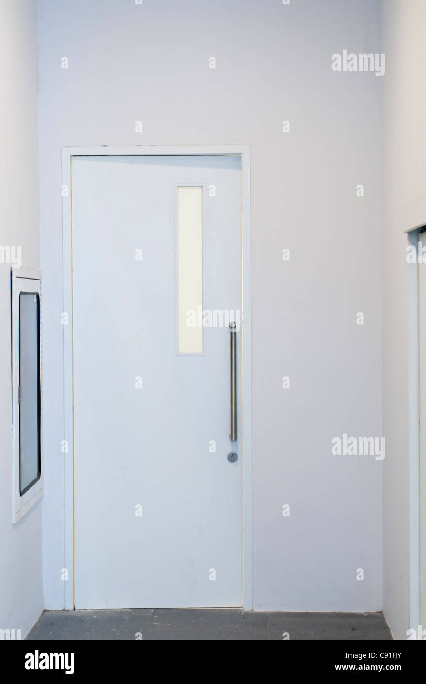 White door with stainless steel handlebar Stock Photo