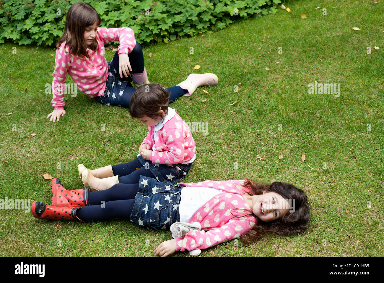 Sisters in matching outfits outdoors Stock Photo
