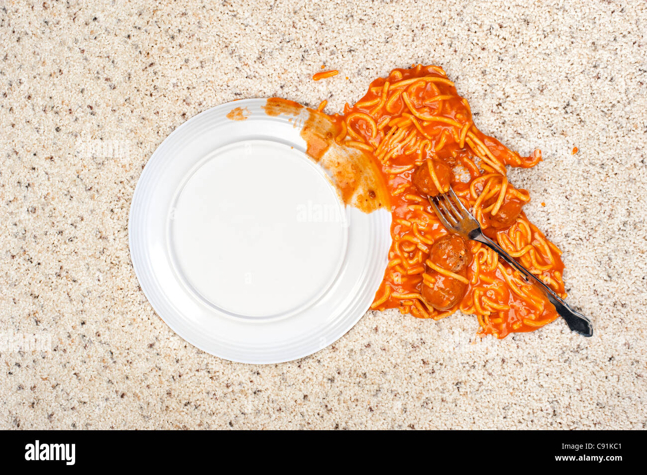 A dropped plate of spaghetti on new carpeting. Stock Photo