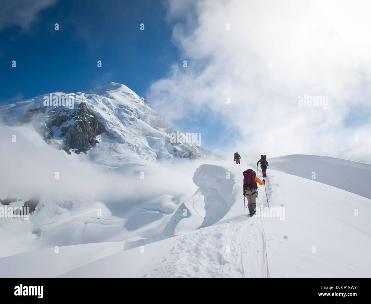 Rope team mountaineering on the narrow ridge of Control Tower above the ...