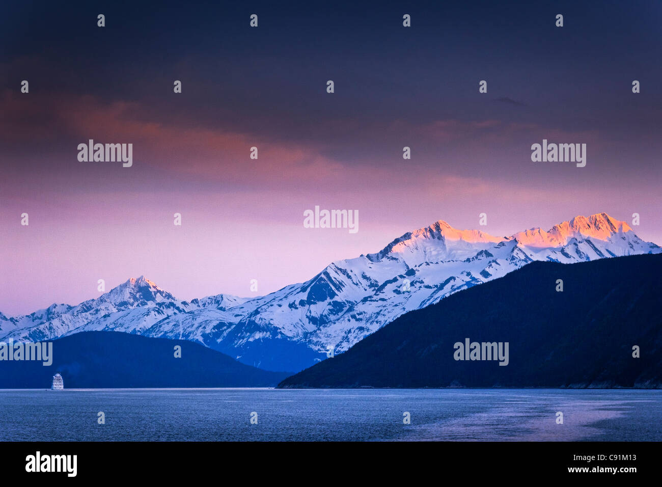 Holland America Cruise Ship New Amsterdam sailing through Lynn Canal at sunset, Inside Passage, near Haines, Southeast Alaska Stock Photo