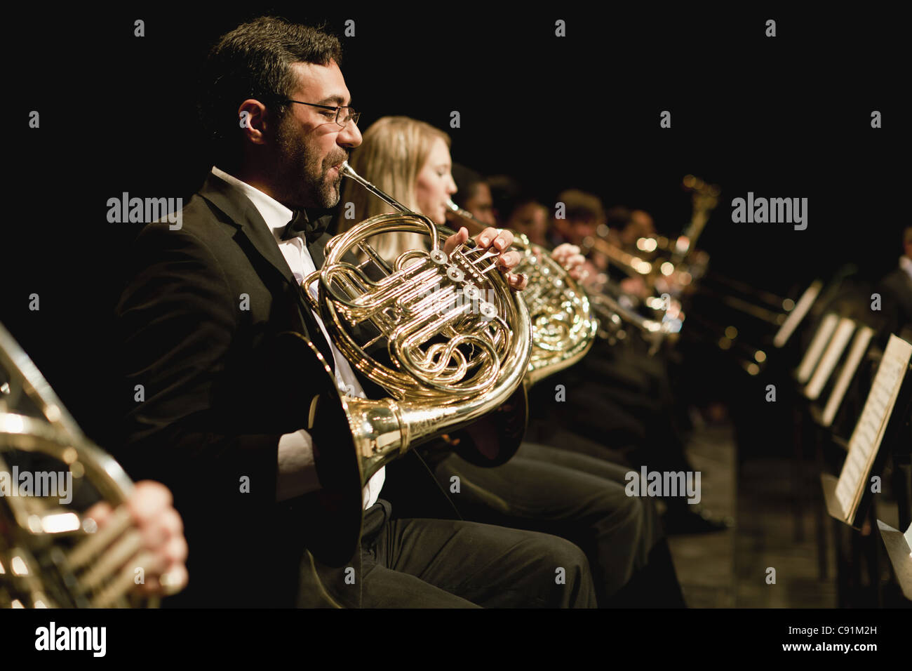 French horn players in orchestra Stock Photo