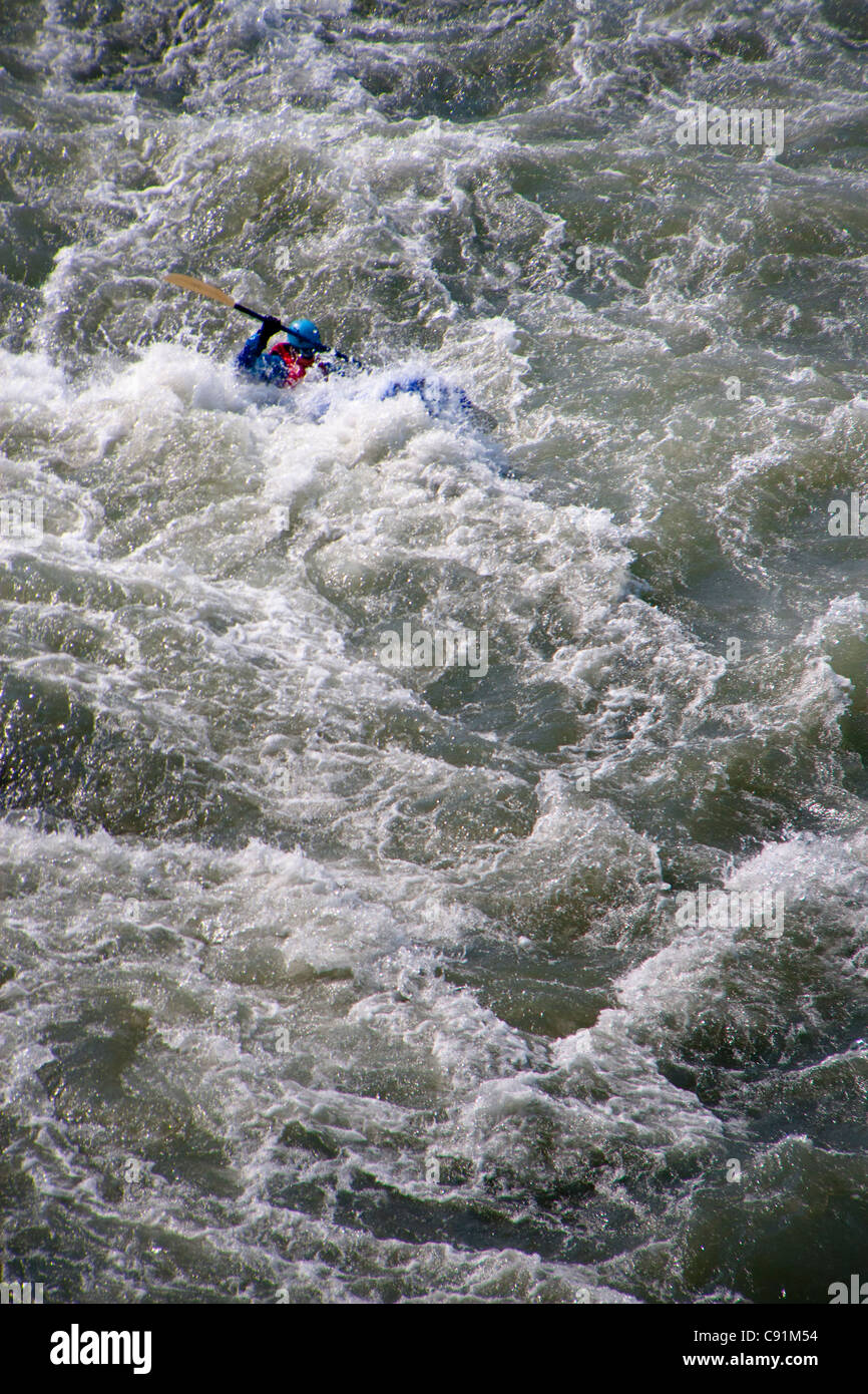 rafter paddles through whitewater on the Hulahula River rapids in a Soar, ANWR, Brooks Range in Arctic Alaska Stock Photo