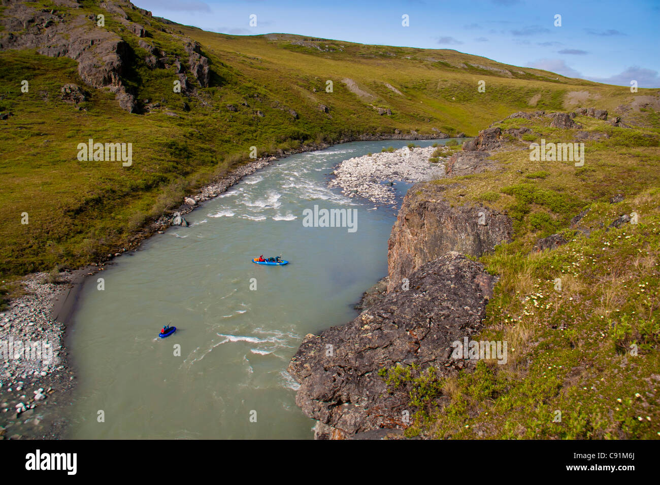 Rafters float down the Hulahula River rapids in a Soar, ANWR, Brooks Range, Summer in Arctic Alaska. Stock Photo