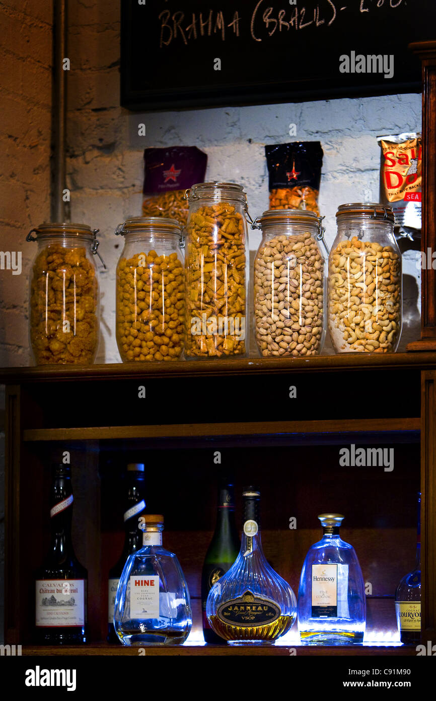 Bottles of alcohol, nuts in jars and blackboard Stock Photo Alamy