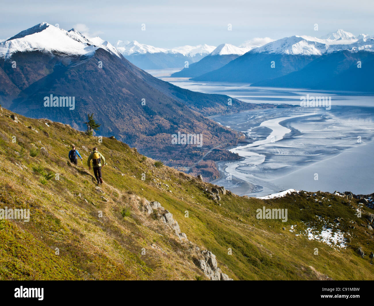 Trail runners traverse tundra on Indian Peak above Indian, Chugach Mountains, Chugach State Park, Fall in Southcentral Alaska Stock Photo
