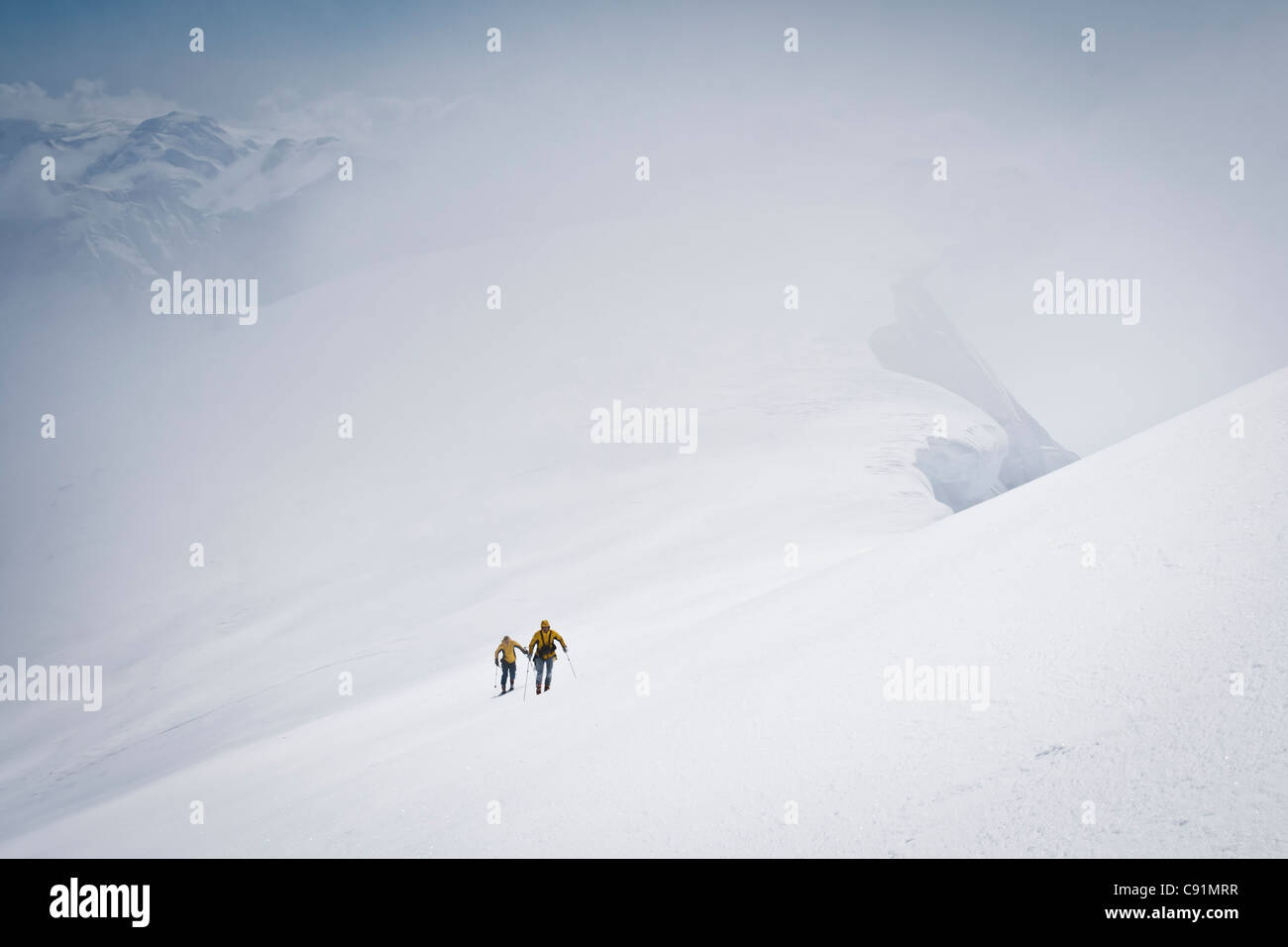 Skiers skiing to the summit of Mount Gerdine in the Tordrillo Mountains, Winter in Southcentral Alaska Stock Photo