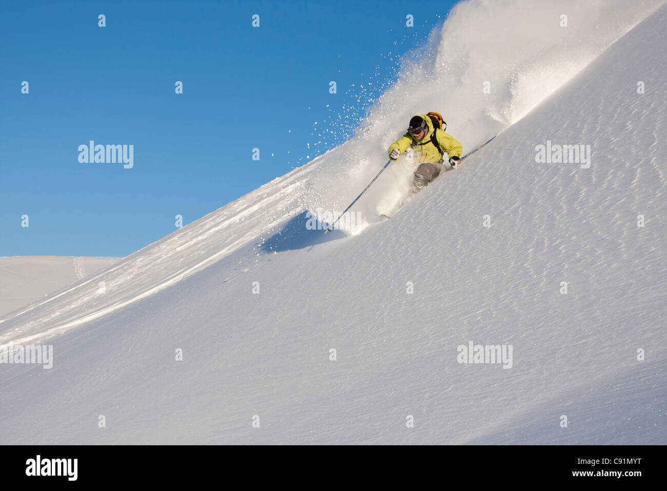 Downhill skier in fresh powder in Chugach Mountains of Turnagain Pass, Southcentral Alaska, Winter Stock Photo