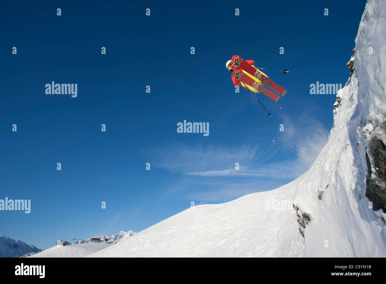Downhill skier makes an extreme jump from a ledge while skiing at Alyeska Resort, Southcentral Alaska, Winter Stock Photo