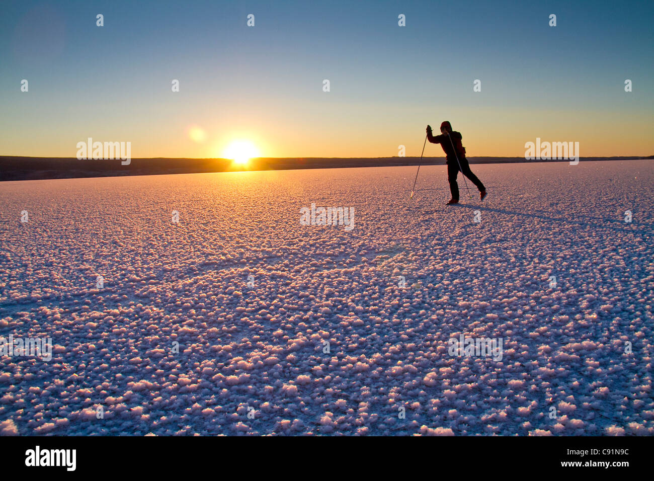Man Nordic ice skating on frozen Skilak Lake, Kenai Peninsula, Southcentral Alaska, Winter Stock Photo