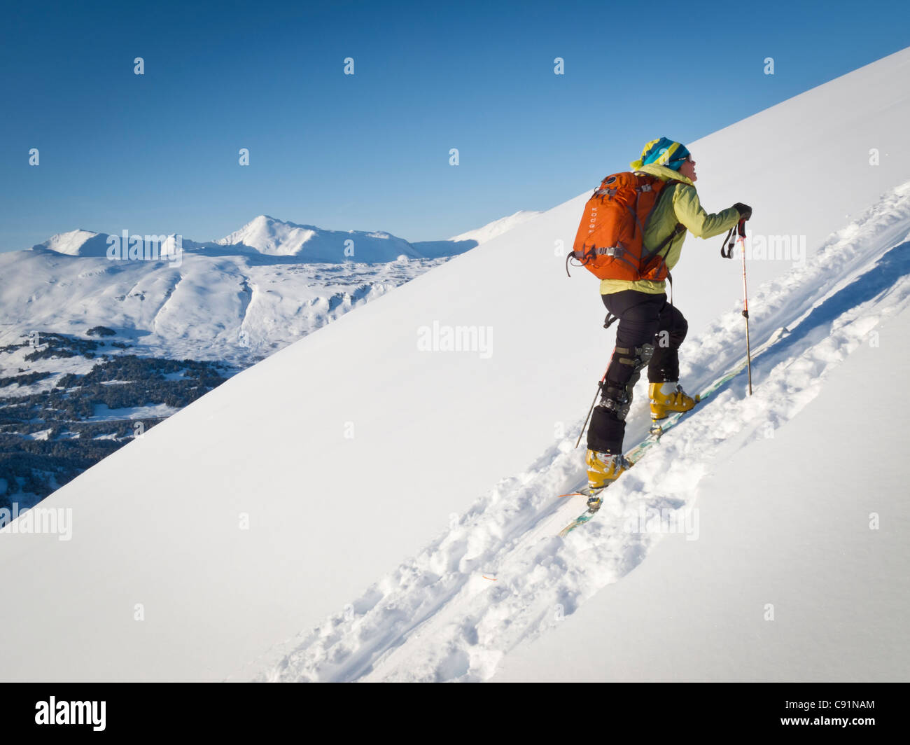 Woman climbing for a backcountry skiing run at Eddies, Turnagain Pass