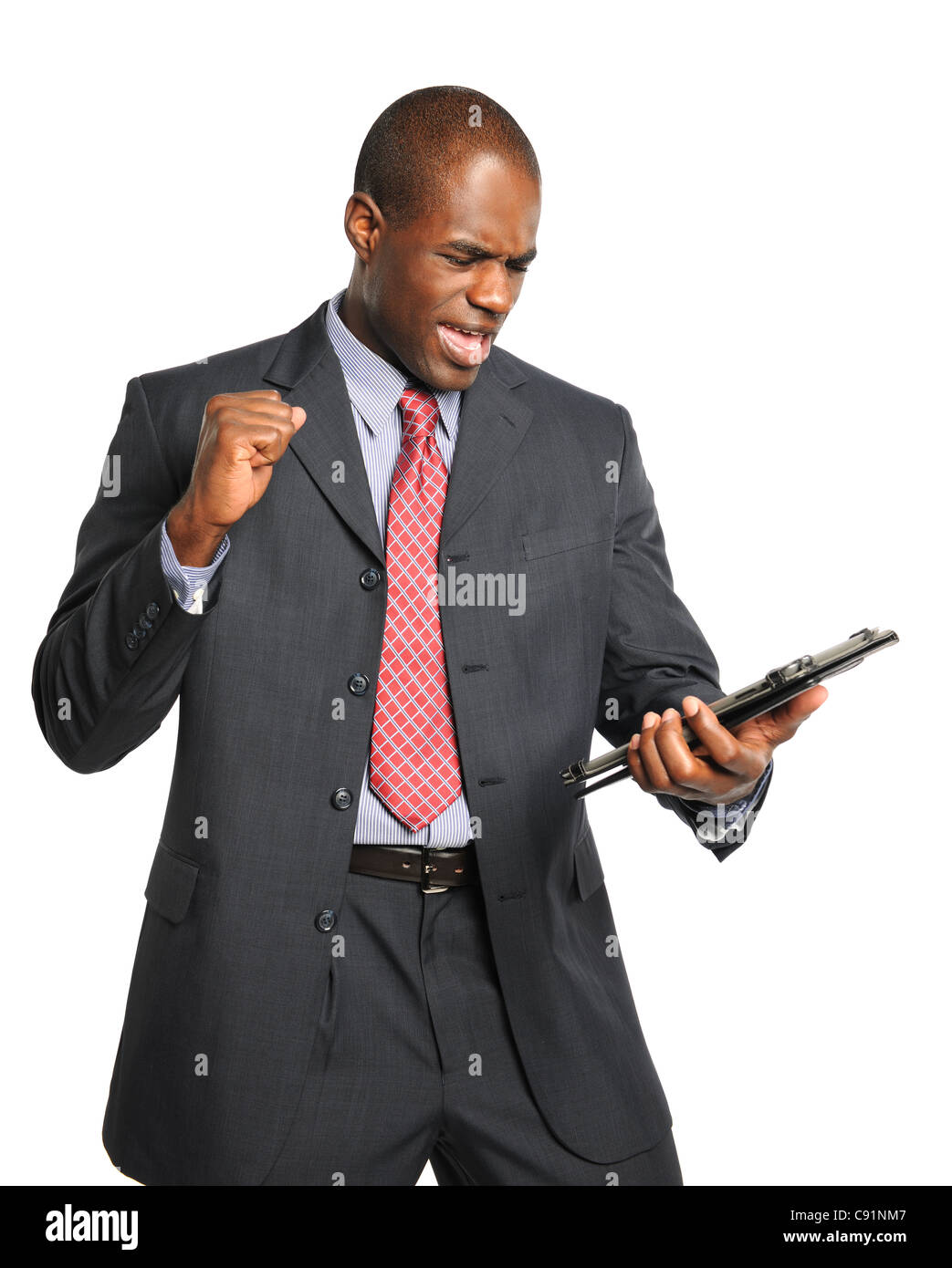 African American businessman celebrating after looking into electronic tablet Stock Photo