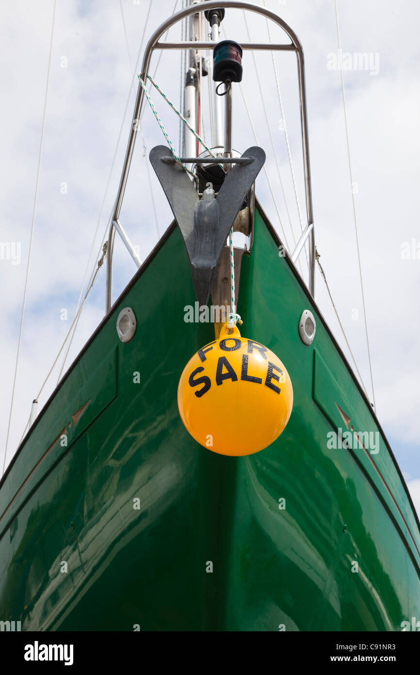 Yacht for sale with green hull and yellow float as a sign, Inverkip, Ayrshire, Scotland Stock Photo