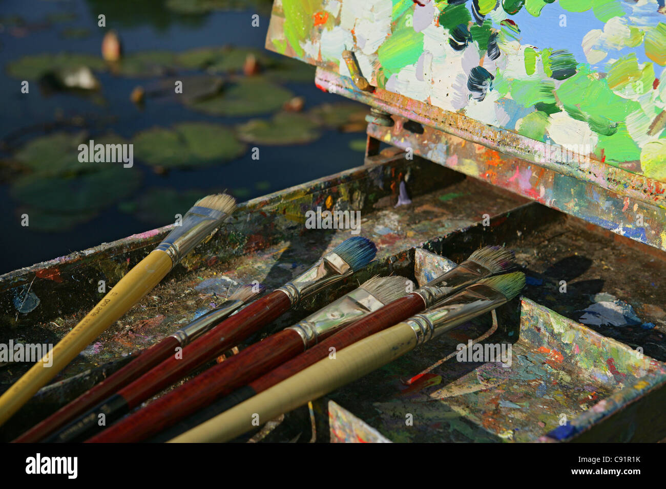 Artists brushes and canvas painting Stock Photo - Alamy