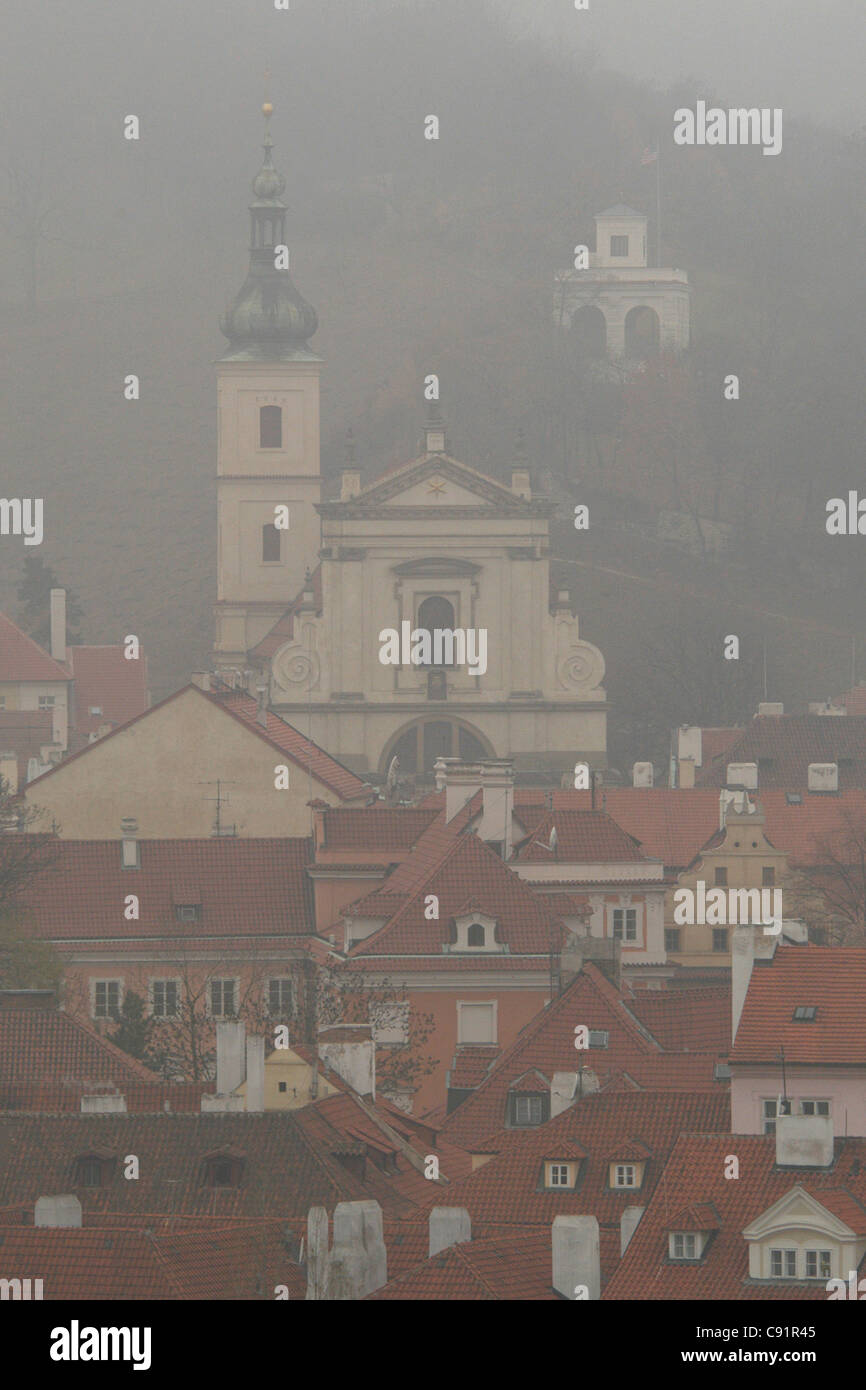 Church of Our Lady Victorious wrapped with morning fog in Prague, Czech Republic. Stock Photo