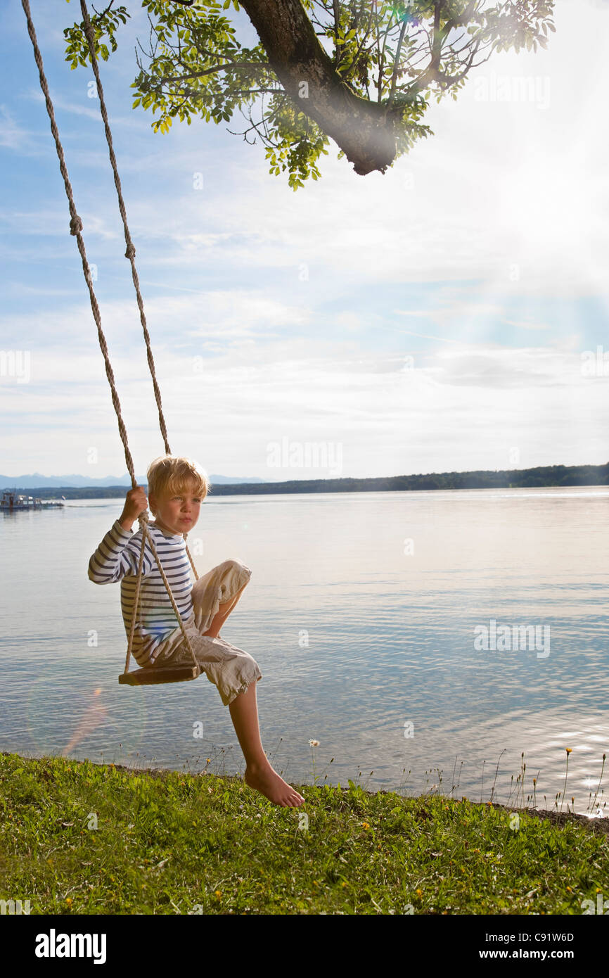 Boy swinging from tree hires stock photography and images Alamy