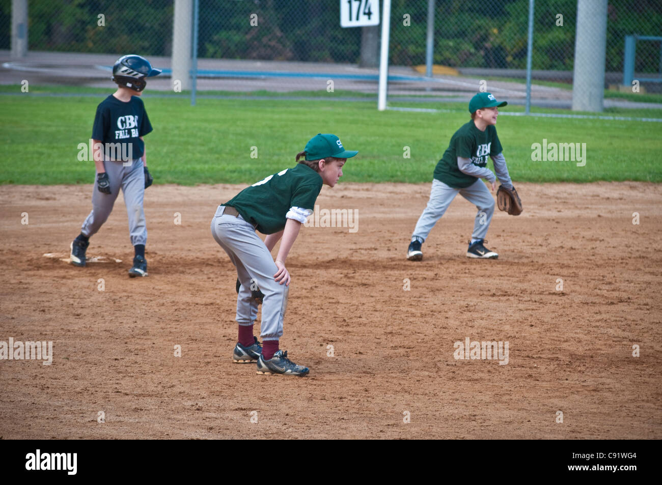 Boys Youth softball baseball game. Base runner Stock Photo - Alamy