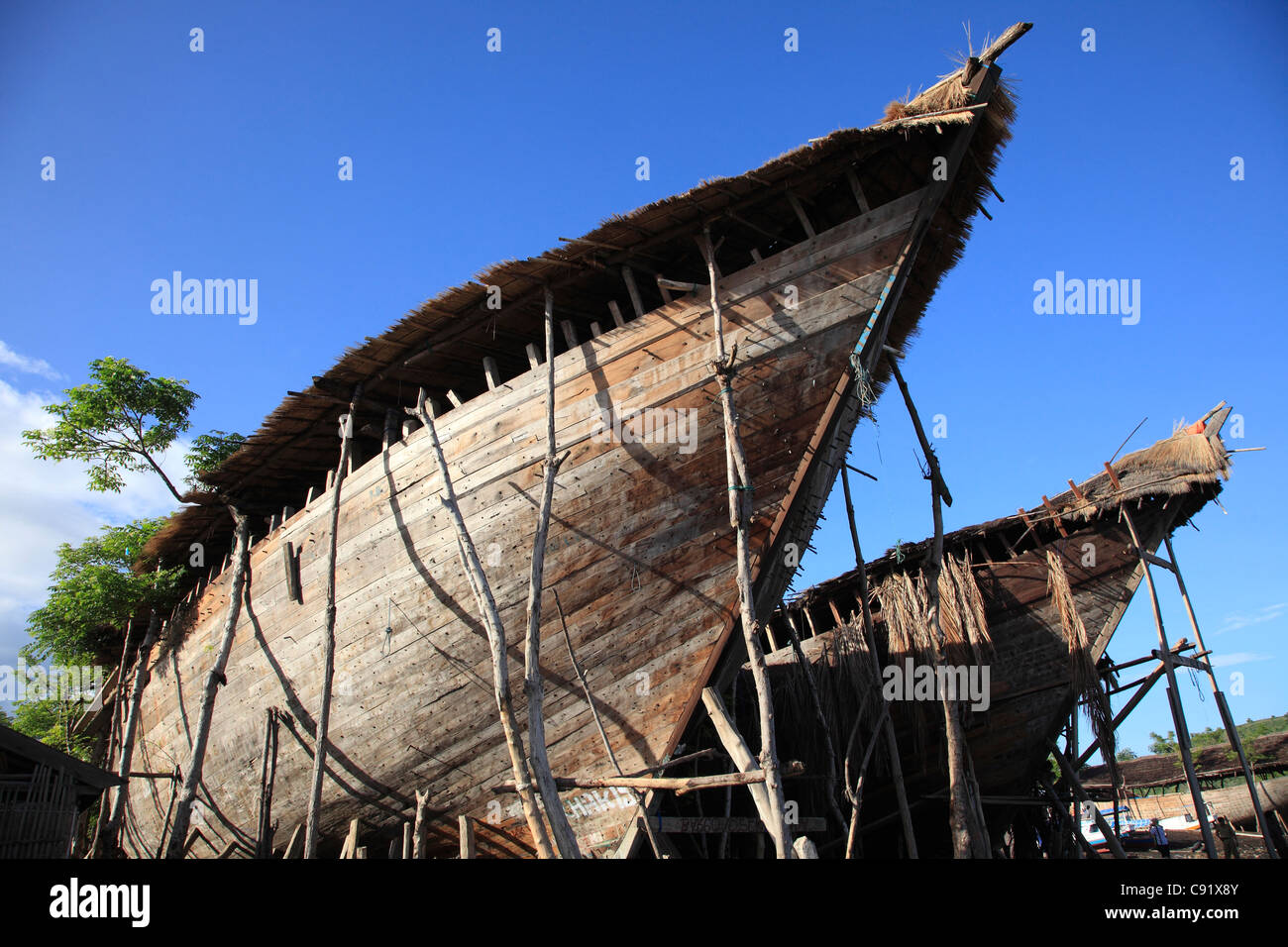 Boat building is one of the major occupations of the coastal communities of Sumbawa island. Wooden boats are constructed on the Stock Photo