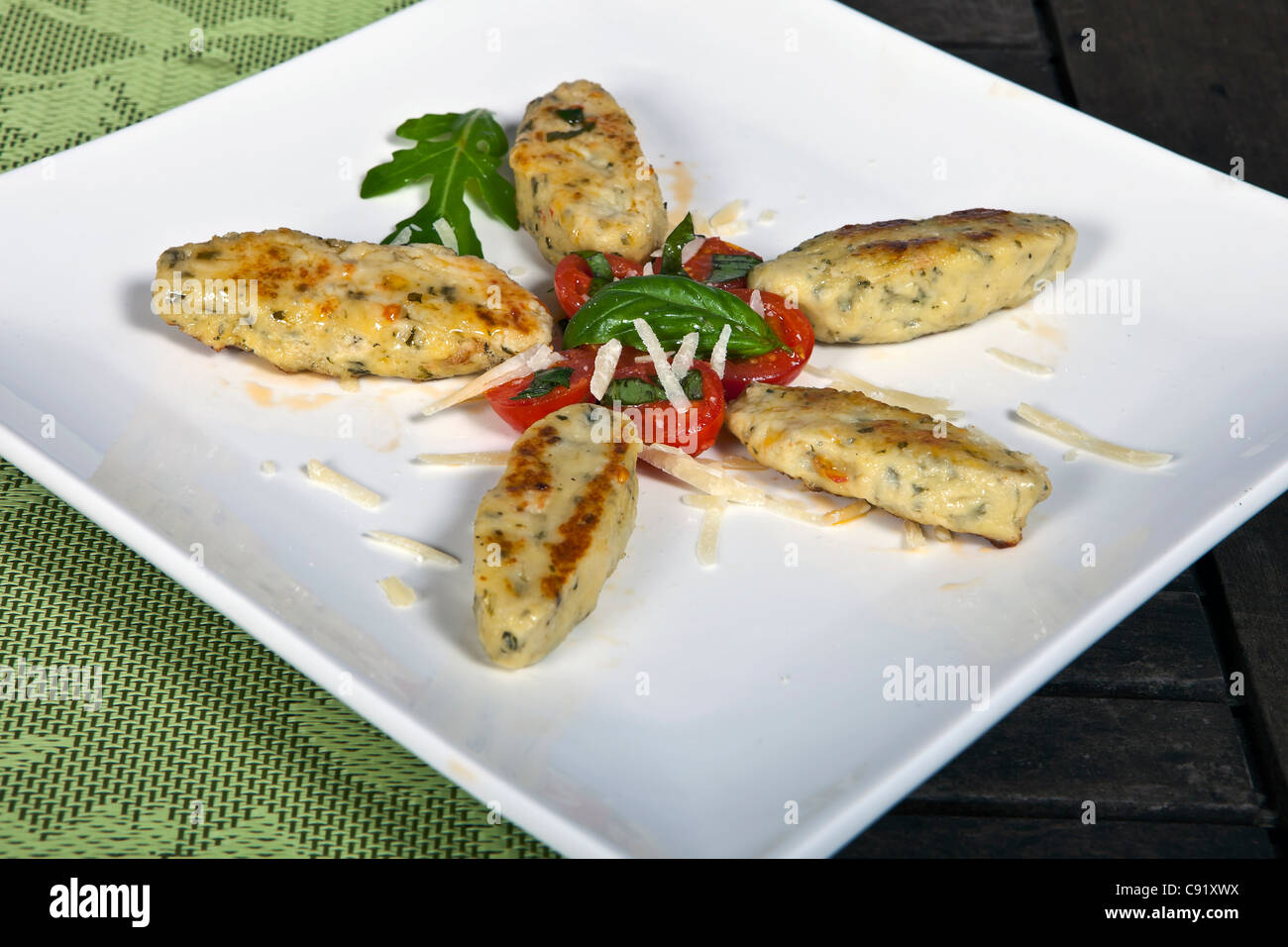 Quark rocket and fried dumplings served with tomatoes Stock Photo