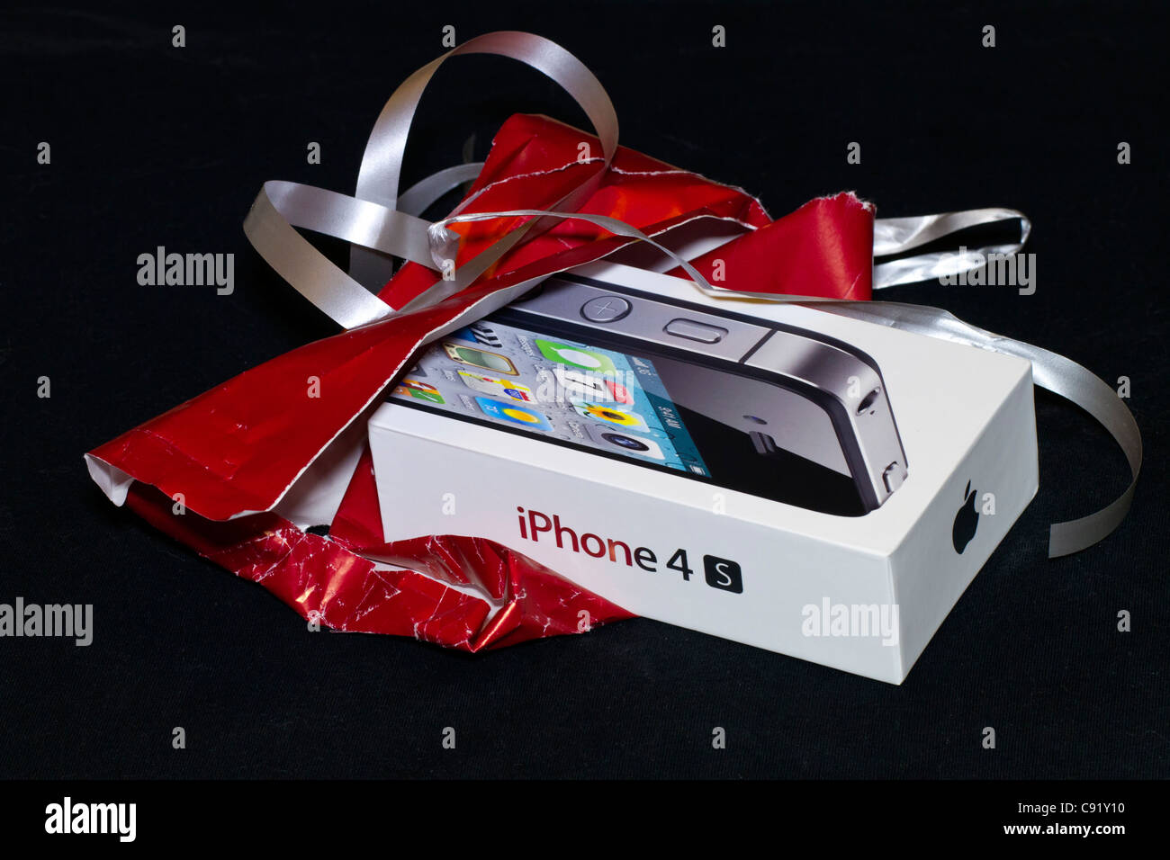 The iPhone 4S in its case, just opened from being gift-wrapped. Stock Photo