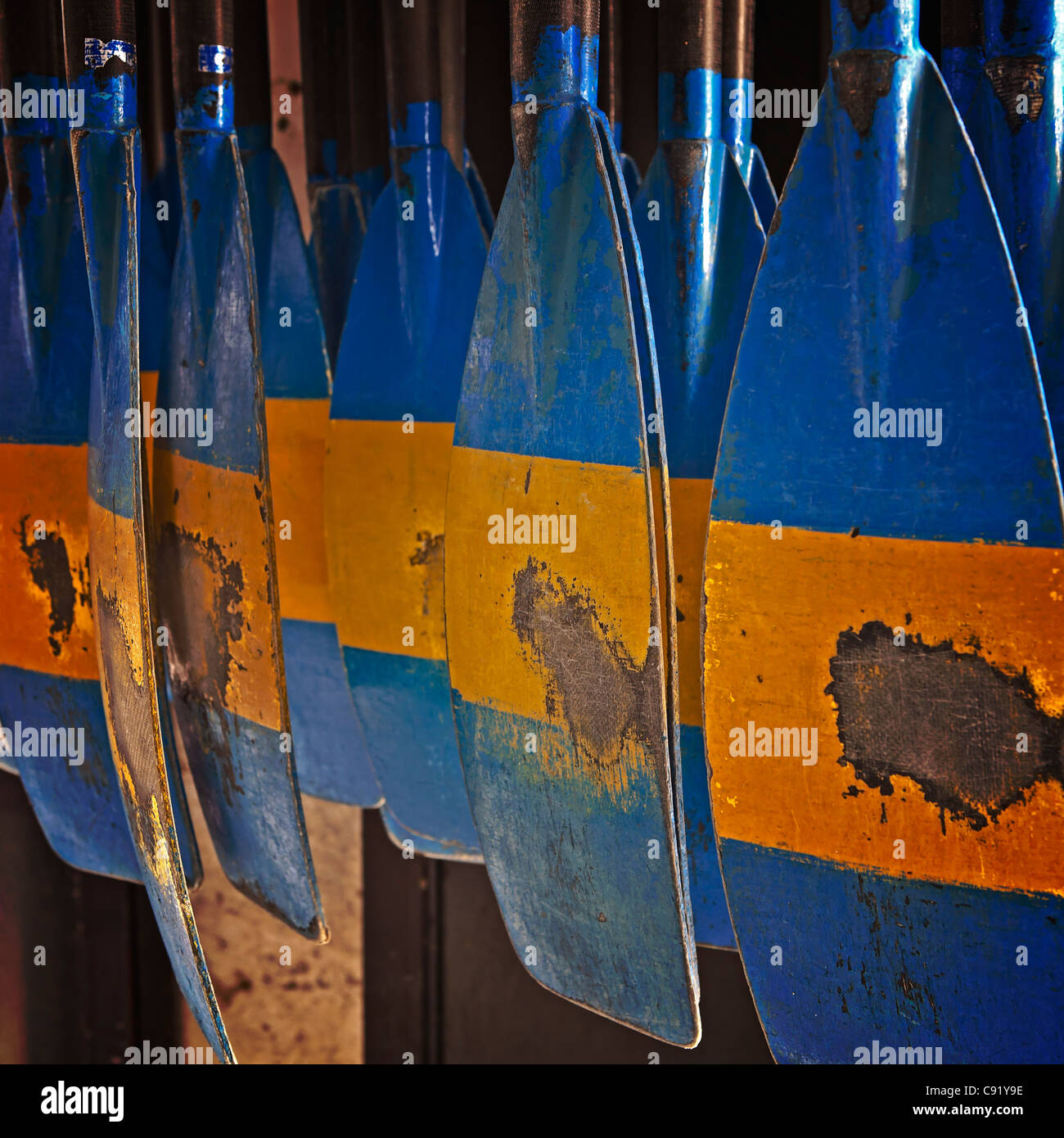 several rudder hung on the wall, painted in color Stock Photo