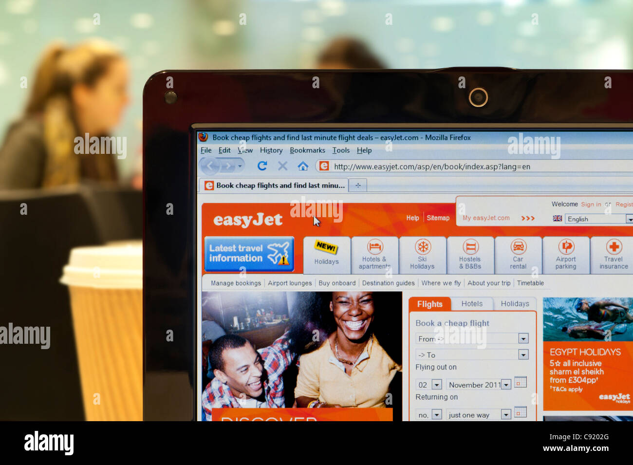 The easyJet website shot in a coffee shop environment (Editorial use only: print, TV, e-book and editorial website). Stock Photo